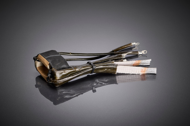 Flach ausgeführter Hochfrequenztransformator mit profilierten HF-Litzen, ausgelegt für hohe Ströme und ein besonders geringes Bauprofil.